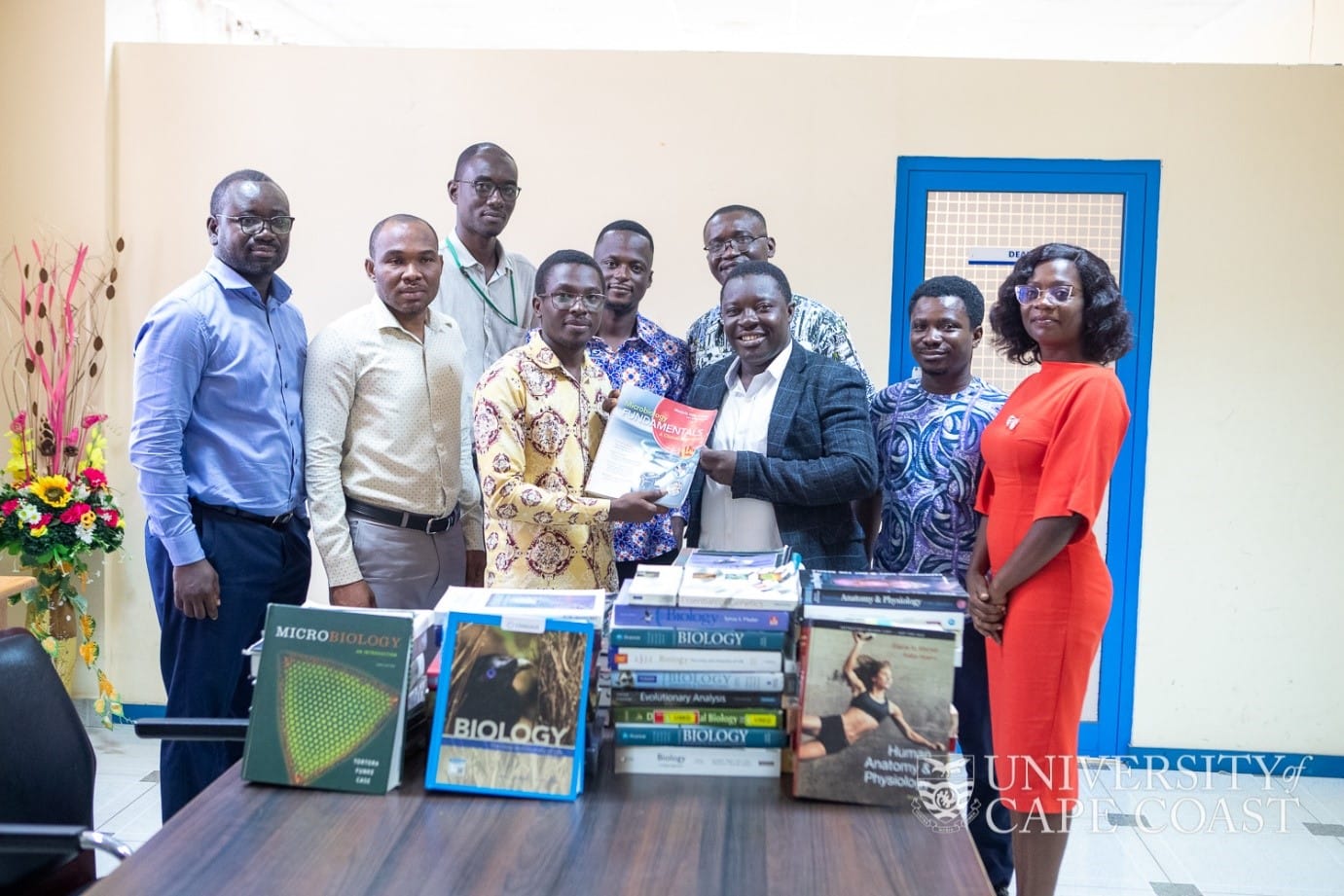 Professor Elvis Ofori-Ameyaw receiving a donation from an international philanthropist
